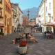 Centro di Aosta con persone sedute sulla panchina, da dove si possono scoprire i castelli e i saperi tipici della Valle d'Aosta